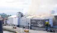 Plumes of smoke billow from the historic Boersen stock exchange building which is on fire in central Copenhagen, Denmark on April 16, 2024. (Photo by Emil Helms / Ritzau Scanpix / AFP) 