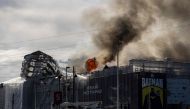 Plumes of smoke billow from the historic Boersen stock exchange building which is on fire in central Copenhagen, Denmark on April 16, 2024. Photo by Emil Nicolai Helms / Ritzau Scanpix / AFP