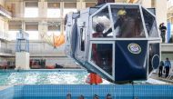 Taiwanese air force personnel take part in water survival and aviation egress training in a specialised pool at a base in Kaohsiung on April 17, 2024. (Photo by I-Hwa CHENG / AFP)