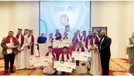 Qatar students and officials with the certificates and medals won at the contest.