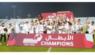 Al Khor players and officials celebrate.