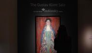 (FILES) A visitor takes a picture of the rediscovered painting of a young female 'Portrait of Miss Lieser' by the Austrian painter Gustav Klimt on a display at the im Kinsky auction house in Vienna, Austria on April 16, 2024. (Photo by Joe Klamar / AFP)