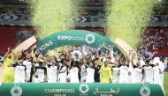 Akram Afif lifts the Falcon Shield as Al Sadd's players celebrate after sealing the ESL title. 