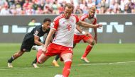 Bayern Munich's English forward #09 Harry Kane scores the 2-1 goal from the penalty spot during the German first division Bundesliga football match between FC Bayern Munich and Eintracht Frankfurt in Munich, southern Germany on April 27, 2024. (Photo by ALEXANDRA BEIER / AFP)