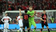 Bayer Leverkusen's Finnish goalkeeper #01 Lukas Hradecky and Bayer Leverkusen's French forward #21 Amine Adli celebrate after the German first division Bundesliga football match Bayer 04 Leverkusen v VfL Stuttgart in Leverkusen, western Germany, on April 27, 2024. (Photo by INA FASSBENDER / AFP) 