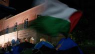 A Pro-Palestinian protestor waves a flag in an encampment at the University of California, Los Angeles (UCLA) campus on May 2, 2024 in Los Angeles, California. Photo by Eric Thayer / GETTY IMAGES NORTH AMERICA / Getty Images via AFP