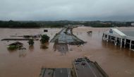 Grab from a handout video released by the Sao Paulo Civil Defense showing the flooded Taquari river bridge, which is part of the BR-396 highway that connects the cities of Lageado and Estrela, in the region of Vale do Taquari, Rio Grande do Sul state, Brazil on May 3, 2024. (Photo by Handout / Sao Paulo Civil Defense / AFP)