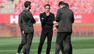 Barcelona's Spanish coach Xavi talks with his technical staff on the pitch before the Spanish league football match between Girona FC and FC Barcelona at the Montilivi stadium in Girona on May 4, 2024. (Photo by LLUIS GENE / AFP)
