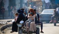Displaced Palestinians travel on a cart in Rafah, southern Gaza Strip, on May 7, 2024, amid the ongoing conflict between Israel and the Palestinian Hamas movement. (Photo by AFP)
