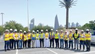 Vodafone Qatar officials with employees during a tour. 