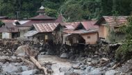 Damaged houses are seen after flash floods and cold lava flow from a volcano in Tanah Datar, West Sumatra, on May 12, 2024.(Photo by REZAN SOLEH / AFP)