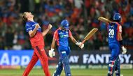 Royal Challengers Bengaluru's Cameron Green (L) celebrates after taking the wicket of Delhi Capitals' Rasikh Salam (C) during the Indian Premier League (IPL) Twenty20 cricket match between Royal Challengers Bengaluru and Delhi Capitals at the M Chinnaswamy Stadium in Bengaluru on May 12, 2024. (Photo by Idrees MOHAMMED / AFP)