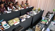 Wahyu Widada (2nd L, seated), head of Indonesia's criminal investigation agency, speaks as seized drugs from a police raid on a suspected drug lab are displayed during a press conference in Tibubeneng Village, Badung Regency on Indonesia's Bali island on May 13, 2024. (Photo by SONNY TUMBELAKA / AFP)
