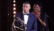 Paris Saint-Germain's French forward #07 Kylian Mbappe celebrates after receiving the Best Players Ligue 1 Award at the end of the TV show at the UNFP (French National Professional Football players Union) trophy ceremony, in Paris on May 13, 2024. (Photo by FRANCK FIFE / AFP)
