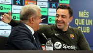 FC Barcelona President Joan Laporta (L) and Barcelona's Spanish coach Xavi react during a press conference in Sant Joan Despi, near Barcelona, on April 25, 2024. (Photo by Lluis Gene / AFP)