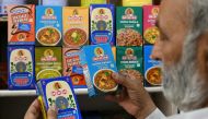 A man buys packets of MDH spices at a store in Amritsar on May 21, 2024. (Photo by Narinder NANU / AFP)