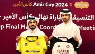 Qatar SC (left) and Al Sadd representatives display their teams’ jerseys for the Amir Cup final. 