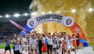 Ain's players celebrate with the winner's trophy after the second leg of the AFC Champions League Final between UAE's Al Ain and Japan's Yokohama F. Marinos at the Hazza Bin Zayed Stadium in Al-Ain on May 25, 2024. (Photo by Giuseppe CACACE / AF