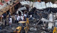 Officials inspect the site of a fire accident on the following day of the disaster, at an amusement park facility in Rajkot, in India's Gujarat state on May 26, 2024. Photo by AFP