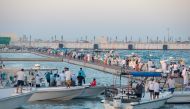 Teams taking part in the fishing competition held at the Old Doha Port.