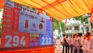 Supporters of the Bharatiya Janata Party (BJP) watch live vote counting figures for India's general election, displayed on a large screen in Varanasi on June 4, 2024. (Photo by Niharika Kulkarni / AFP)