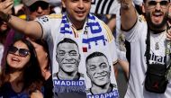Supporters wearing football scarves depicting French footballer Kylian Mbappe cheer prior Real Madrid's celebration for winning 2024 Spanish La Liga title at Cibeles square in Madrid on May 12, 2024. Photo by OSCAR DEL POZO / AFP