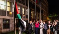 People hang a Palestinian flag in front of the Parliament building after the National Assembly recognised the Palestinian state following a parliamentary vote in Ljubljana, on June 4, 2024. Photo by AFP.
