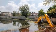 An excavator is marooned in flood water near homes that have been abandoned by their owners at Nairobi's plush Runda estate following recent heavy rainfall in Nairobi on June 05, 2024. (Photo by Tony Karumba / AFP)
