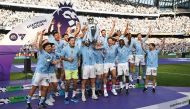 File: Manchester City’s Kyle Walker holds aloft the Premier League trophy during the presentation ceremony yesterday. AFP

