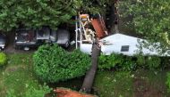 Maryland - June 06: In this aerial view, a home is crushed by a fallen tree, knocked down a day earlier by a tornado in the Olde Towne neighborhood, on June 06, 2024 in Gaithersburg, Maryland. ( (Photo by CHIP SOMODEVILLA / GETTY IMAGES NORTH AMERICA / Getty Images via AFP)