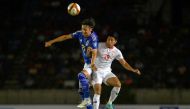 Japan's Hiroki Ito (L) and Myanmar's Thein Than Win (R) jump together as they challenge for the ball during the 2026 FIFA World Cup AFC qualifiers football match between Myanmar and Japan at Thuwunna Stadium in Yangon on June 6, 2024. Photo by Sai Aung MAIN / AFP.
 
