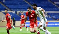 Qatar's Homam Al Amin (right) vies for the ball with Afghanistan's Amid Arezou during their match at Prince Abdullah bin Jalawi Stadium in Al Ahsa, Saudi Arabia, on Thursday.