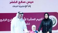 Assistant Undersecretary for Special Education Affairs Omar Abdul Aziz Al Naama (left) and Director of Private Schools and Kindergartens Dr. Rania Mohammed honouring a winner during the ceremony.