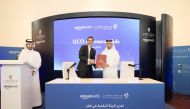 GCO Director Sheikh Jassim bin Mansour bin Jabor Al Thani (right) and International Expansion Managing Director EMEA and Southeast Asia at Amazon, Rayan Karaky, exchanging documents after signing the agreement in Doha, yesterday.