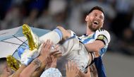 File:  Argentina's forward Lionel Messi is thrown up in the air by teammates during a recognition ceremony for the World Cup winning players, following the friendly football match between Argentina and Panama at the Monumental stadium in Buenos Aires on March 23, 2023. (Photo by Juan Mabromata / AFP)
