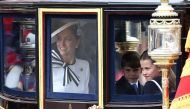 Britain's Catherine, Princess of Wales, smiles next to Britain's Princess Charlotte of Wales (R) and Britain's Prince Louis of Wales (C) inside the Glass State Coach on June 15, 2024. (Photo by Henry Nicholls / AFP)