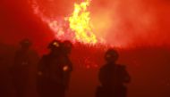 Firefighters from the Los Angeles Fire Department (LAFD) and other firemen respond to the Post Fire as it burns through the Hungry Valley State Vehicular Recreation Area in Lebec, California, on June 16, 2024. (Photo by DAVID SWANSON / AFP)
