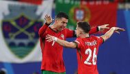 Portugal's forward #07 Cristiano Ronaldo and second goal-scorer, Portugal's forward #26 Francisco Conceicao celebrate on the pitch after the UEFA Euro 2024 Group F football match between Portugal and the Czech Republic at the Leipzig Stadium in Leipzig on June 18, 2024. (Photo by Adrian DENNIS / AFP)

