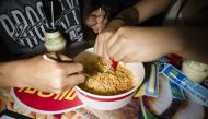 Tourists prepare Buldak ramyeon - South Korea's famed