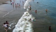 People visit the beach at Coney Island on a sweltering afternoon on the first weekend of summer on June 22, 2024 in the Brooklyn borough of New York City. (Photo by SPENCER PLATT / GETTY IMAGES NORTH AMERICA / Getty Images via AFP)

