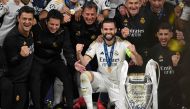 (Files) Real Madrid's Spanish defender #06 Nacho Fernandez celebrates with the trophy after winning the UEFA Champions League final football match on June 1, 2024. (Photo by Paul Ellis / AFP)