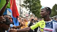 Intermarche - Wanty team's Eritrean rider Biniam Girmay celebrates with supporters after winning the 3rd stage of the 111th edition of the Tour de France cycling race, 230,5 km between Piacenza and Turin, in Italy, on July 1, 2024. (Photo by Marco BERTORELLO / AFP)
