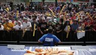 People attend the 2024 Nathan's Famous Fourth of July hot dog eating competition at Coney Island in the Brooklyn borough of New York on July 4, 2024. (Photo by Leonardo Munoz / AFP)