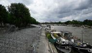 A general view shows stands under construction along the banks of the Seine River ahead of the upcoming Paris 2024 Olympics, in Paris on July 3, 2024. (Photo by JULIEN DE ROSA / AFP)

