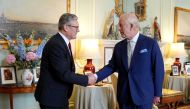 Britain's King Charles III (right) welcomes Britain's incoming Prime Minister Keir Starmer during an audience at Buckingham Palace in London on July 5, 2024, a day after Britain held a general election. (Photo by Yui Mok / POOL / AFP)