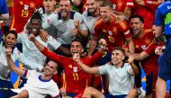 Spain's players celebrate after winning the UEFA Euro 2024 semi-final football match between the Spain and France at the Munich Football Arena in Munich on July 9, 2024. (Photo by Odd Andersen / AFP)