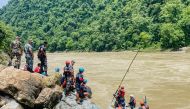 Members of Nepal's Armed Police Force (APF) search for survivors in the Trishuli River at the site of a landslide following heavy rainfall in Simaltar on July 13, 2024. (Photo by Rajesh Ghimire / AFP)