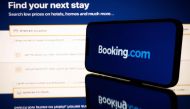 (FILES) This file photo shows screens displaying the logo and the website of the online travel and accommodation services platform Booking.com in Toulouse, southwestern France on January 25, 2023. (Photo by Lionel BONAVENTURE / AFP)
