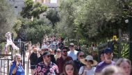 Tourists leave the Acropolis hill in Athens on July 17, 2024. (Photo by Aris Oikonomou / AFP)
 
