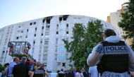 A Forensic police officer works outside a building after French Firefighters extinguishing a fire that broke out overnight at a residential building in a working-class neighbourhood of the southern French city of Nice, killed seven people, southern France, on July 18, 2024. (Photo by Valery HACHE / AFP)